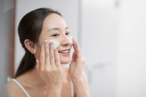 young girl washing her face with soap. - facial cleanser imagens e fotografias de stock