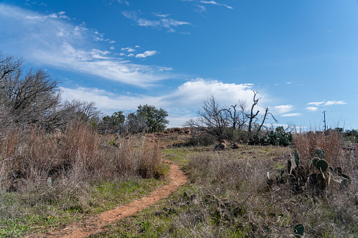 View of Curved Walking Dirt Trail With Sunny Clear Skies in Texas