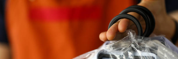 istock Clothes dry cleaning service worker returning shirts to customer 1210019387