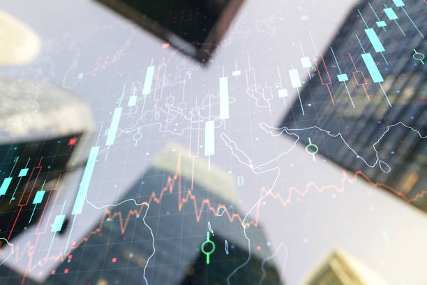 istock Double exposure of abstract financial graph with world map on office buildings background, financial and trading concept 1210021910