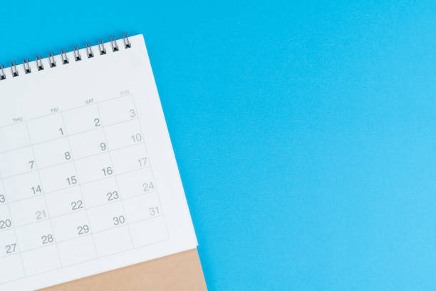 istock Calendar on blue background with copy space and blank space to put month and year using as reminder, plan and appointment concept 1210023594