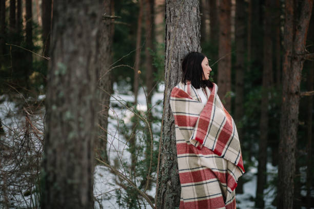 istock Young girl wearing blanked resting on tree 1210023921