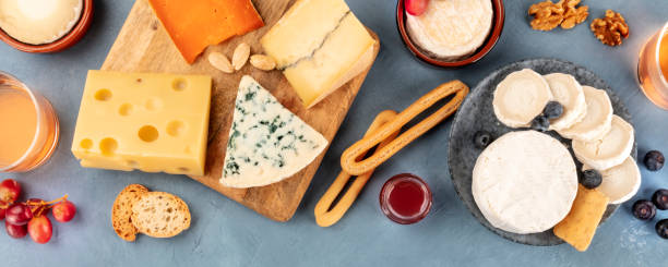 istock Cheese panoramic flat lay. Blue cheese, Brie, Emmental, goat cheese, and others, shot from the top 1210024834