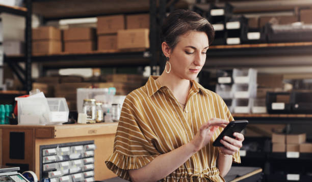 A small device for big designs Shot of a businesswoman using a digital tablet in a creative office warehouse office stock pictures, royalty-free photos & images