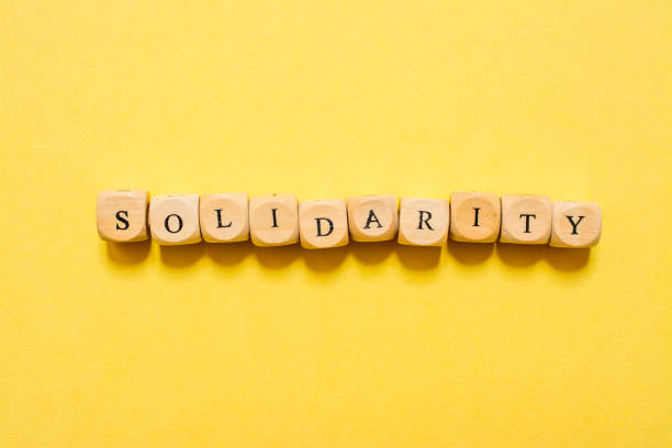 istock the word Solidarity, text made with dice on yellow background 1210030185