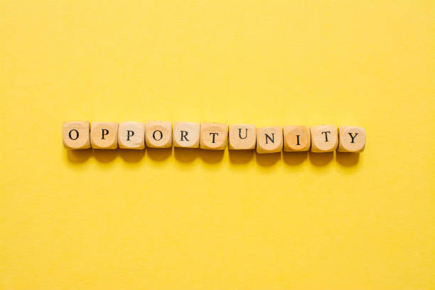 istock the word Opportunity, text made with dice on yellow background 1210030406