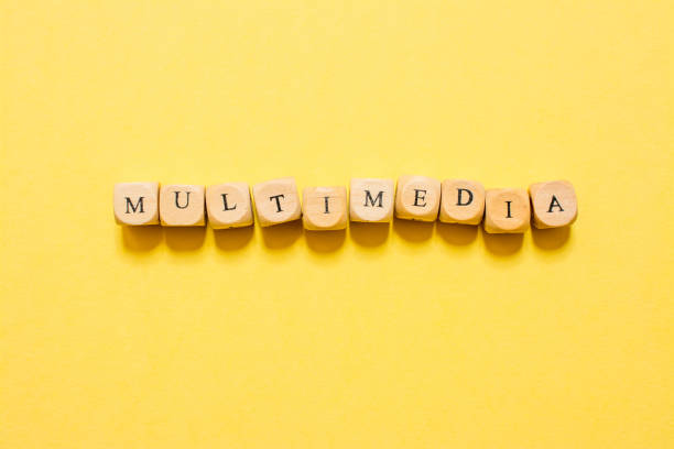 istock the word Multimedia, text made with dice on yellow background 1210030546