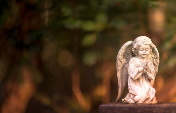 istock white angel figure on tombstone 1210031470