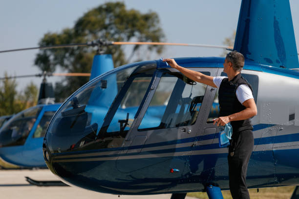 istock Man wiping helicopter exterior after flight with cloth 1210031703
