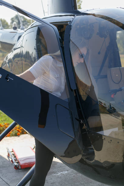 istock Female pilot opening helicopter door 1210031725