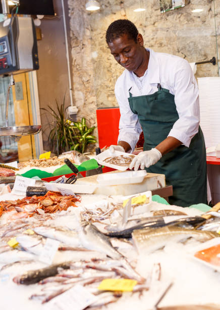 istock Salesman preparing fish for sale 1210031782