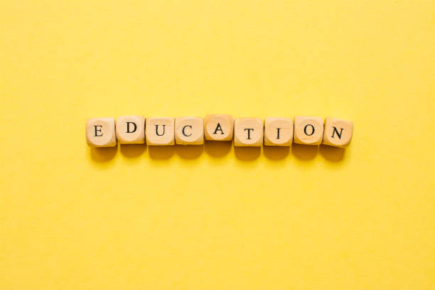 istock the word Education, text made with dice on yellow background 1210032009