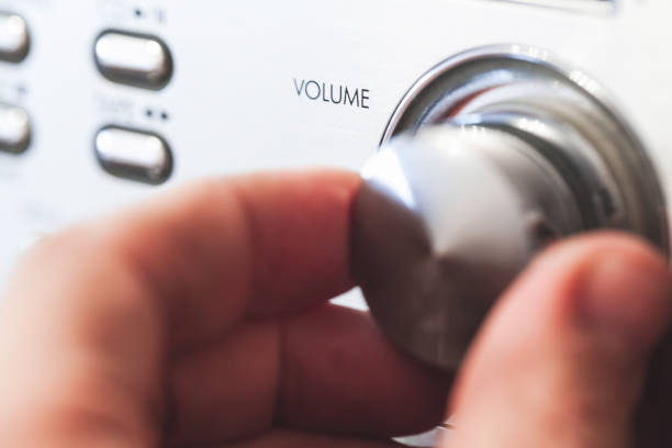 istock Hand on a volume control knob, close up-photo 1210033715