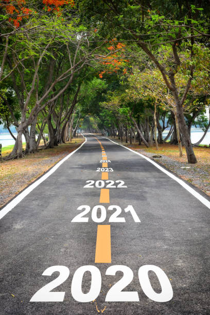 istock Tree tunnel with 2020 to 2026 on asphalt road surface 1210035440