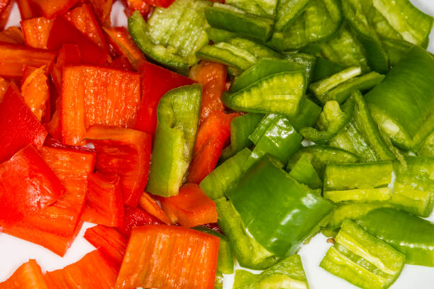 Nutritional supplement with cross section of red bell pepper and knife on the cutting board.