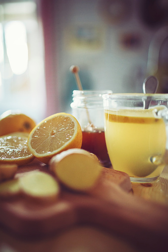 Fresh hot lemon with ginger prepared in a pretty country house kitchen
