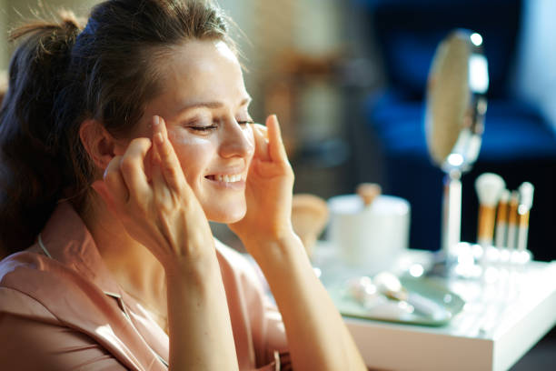 istock happy modern woman applying eye cream 1210038626