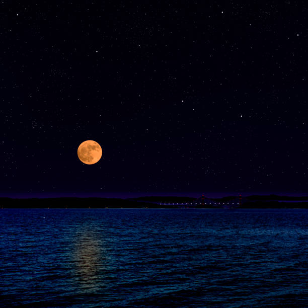 Full moon rising over the peninsula with lots of shining stars.