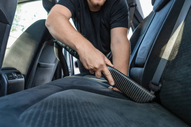 istock man cleaning inside car with vacuum cleaner 1210041412