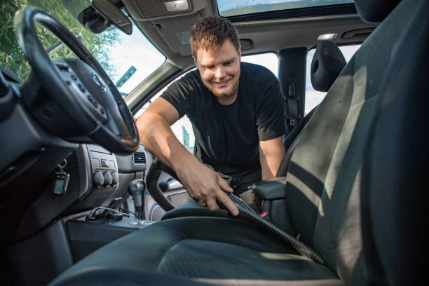 istock man cleaning inside car with vacuum cleaner 1210041442