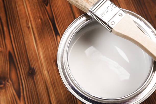 istock House renovation, paint can on the old wooden background with copy space 1210041675