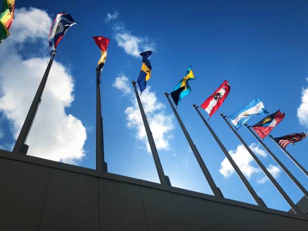 istock Close up group of colorful various countries flags at flagpoles 1210041753