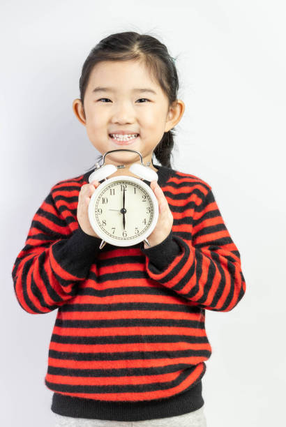 Little Girl Holding Alarm Clock