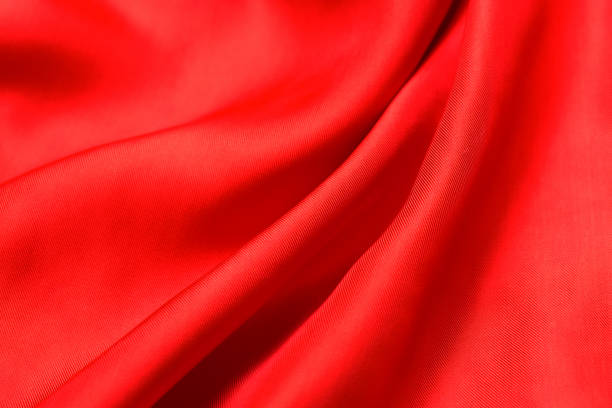 istock fabric texture. abstract background with soft waves. Smooth elegant red silk or satin luxury cloth 1210041967