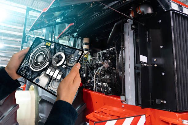 Serviceman repairing a tractor