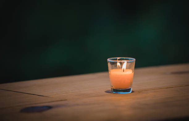 A glass candle to light at night stock photo