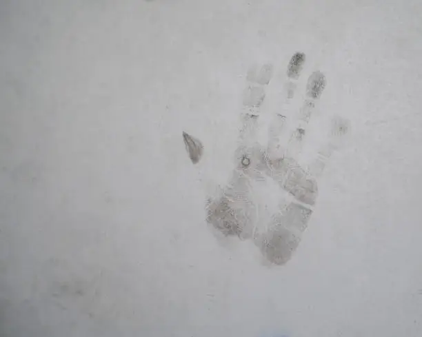 Palm marks on the concrete wall