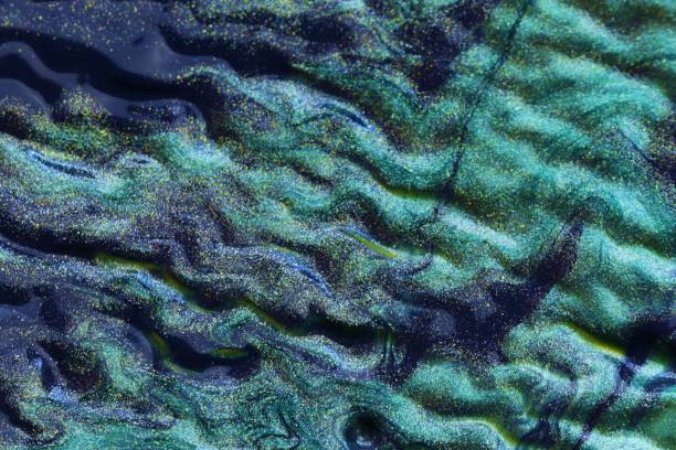 istock Aqua Menthe waves texture. Turquoise glitter background. Blue green macro texture.Trend color 2020 1210045824