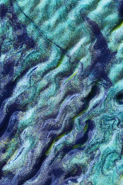 istock Aqua Menthe waves texture. Turquoise glitter background. Blue green macro texture.Trend color 2020 1210045828