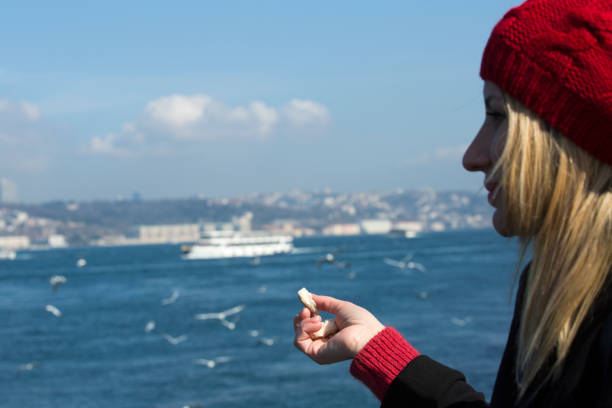 People feeding seagulls on Uskudar wateront in the shores of Bosphorus