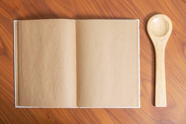 istock Recipe book and spoon on wooden table 1210048925