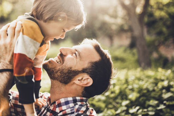 istock Happy single father and son having fun while talking in nature. 1210048979