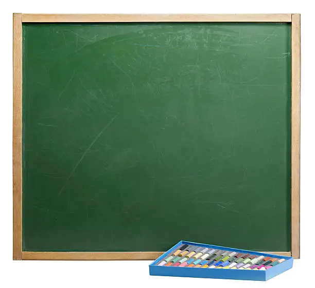old used blackboard and a box of crayons. Studio photography in white back