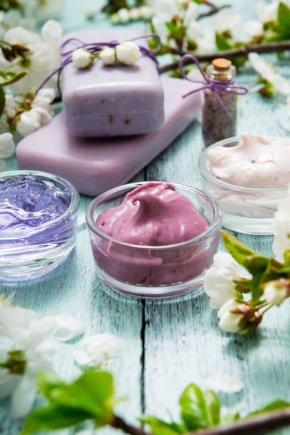 istock Cosmetics and cherry flowers on blue wooden table 1210049423