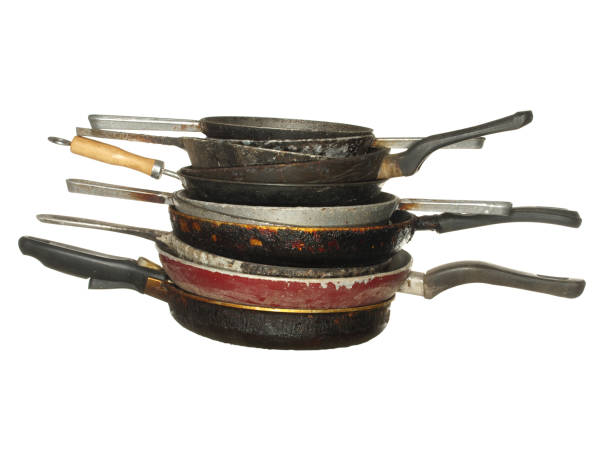 istock Stack of used old pans isolated on a white background. 1210050446