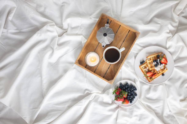 istock Beautiful breakfast in bed: Viennese Belgian waffles decorated with berries, a plate with strawberries and blueberries 1210051254