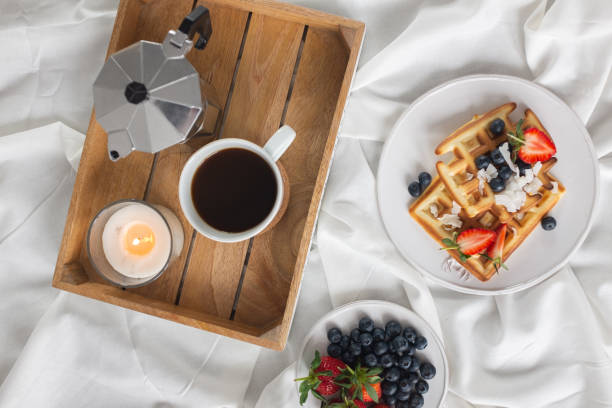 istock Beautiful breakfast in bed: Viennese Belgian waffles decorated with berries, a plate with strawberries and blueberries 1210051403