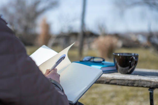 Writing in notebook in the nature stock photo