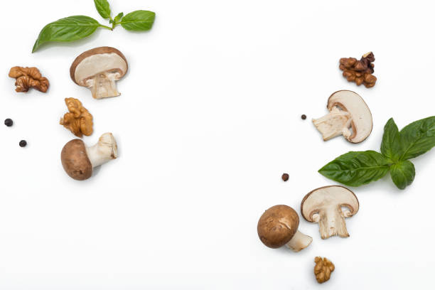 istock Basil leaves, slices of mushrooms and nuts, isolayed on clear white background with copy space 1210051771