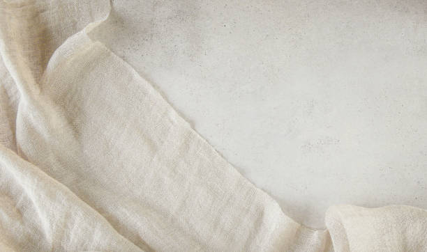 Pure washed linen cloth on light grunge stone background.
