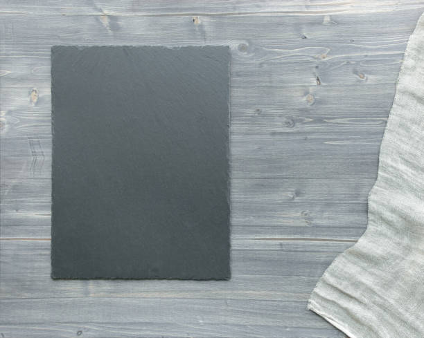 istock Empty slate tray and linen cloth on wooden background. 1210051863