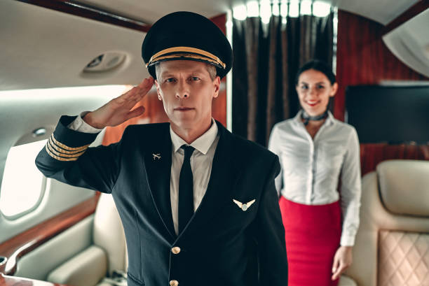istock Pilot and flight attendant in private jet 1210052860