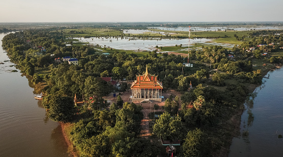 Mekong River drone shot of Delta village aerial view with temple