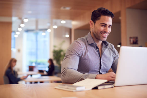 istock Businessman At Desk In Modern Office Work Space With Laptop 1210054722
