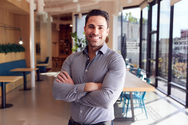 istock Portrait Of Businessman Standing In Modern Open Plan Office 1210054869