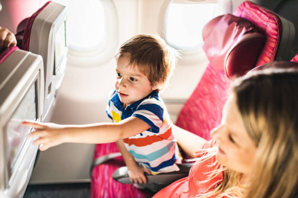 istock Small boy showing something to his mother in an airplane. 1210055113